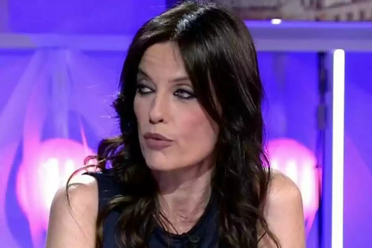 Cristina Seguí de cabell fosc i llarg amb expressió seriosa en un plató de Codi 10 il·luminat amb llums liles