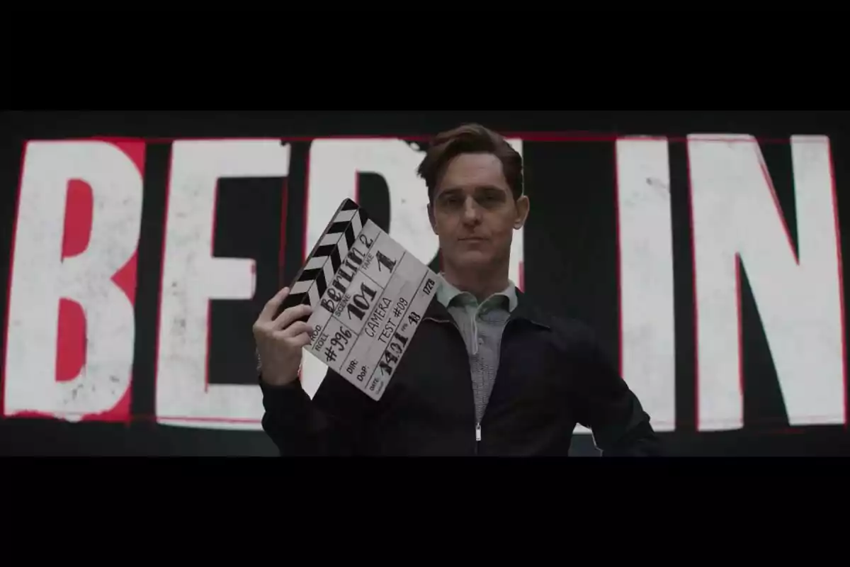 Pedro Alonso sostiene una claqueta frente a un fondo con letras grandes que dicen "BERLIN".