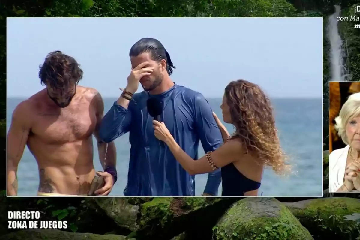 Personas en una competencia de juegos en la playa, una mujer entrevistando a un hombre visiblemente emocionado mientras otro hombre está a su lado. Personas en una competencia de juegos en la playa, una mujer entrevistando a un hombre visiblemente emocionado mientras otro hombre está a su lado.