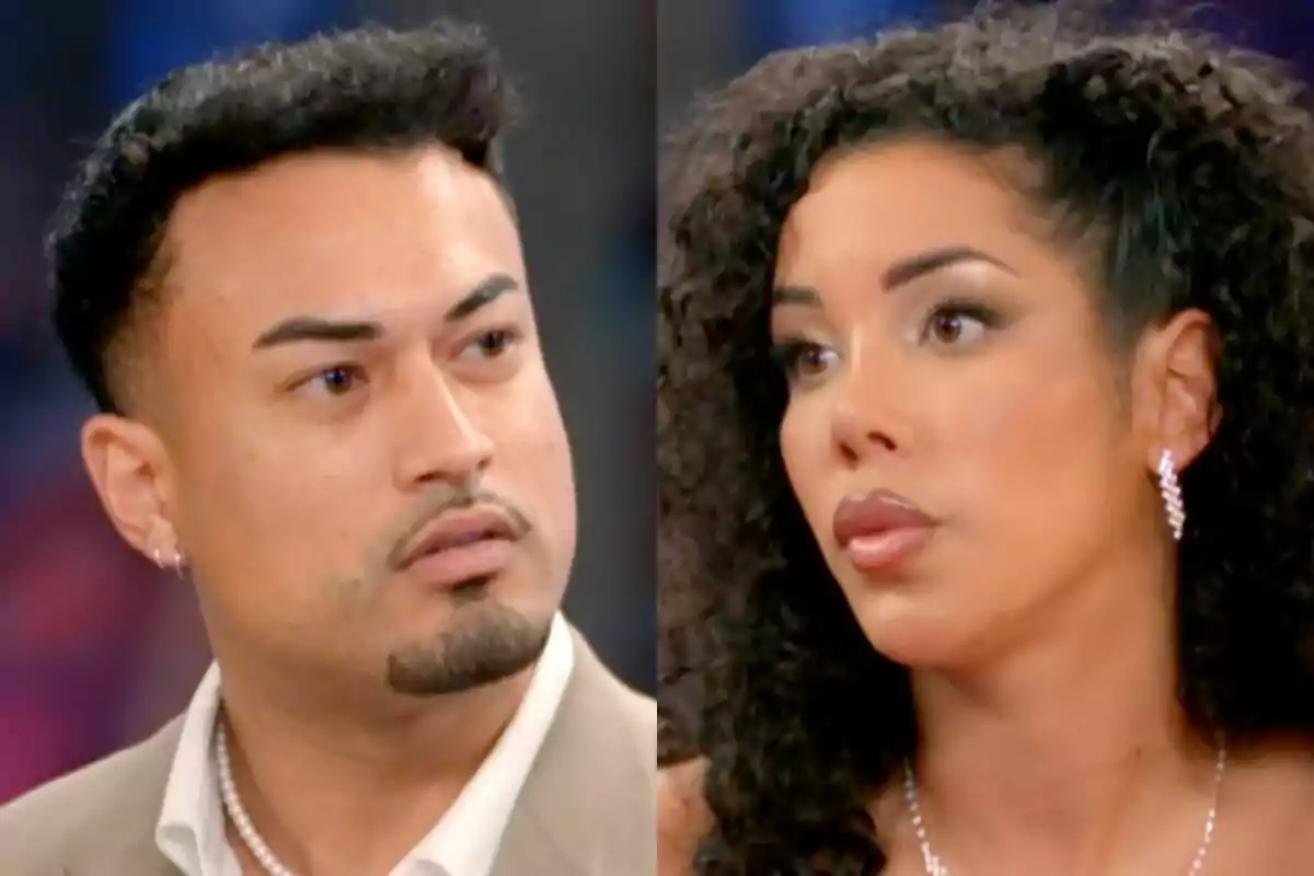 Bayan y Eros mirándose con expresiones serias en un entorno iluminado en La Isla de las Tentaciones.