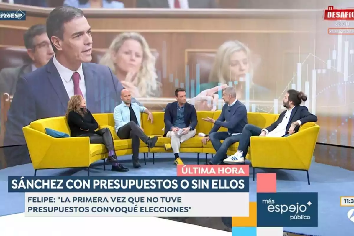 Un grupo de personas está sentado en 'Espejo Público' con un fondo que muestra a un político hablando en un parlamento, mientras en la pantalla se leen titulares relacionados con presupuestos y elecciones. Un grupo de personas está sentado en 'Espejo Público' con un fondo que muestra a un político hablando en un parlamento, mientras en la pantalla se leen titulares relacionados con presupuestos y elecciones.