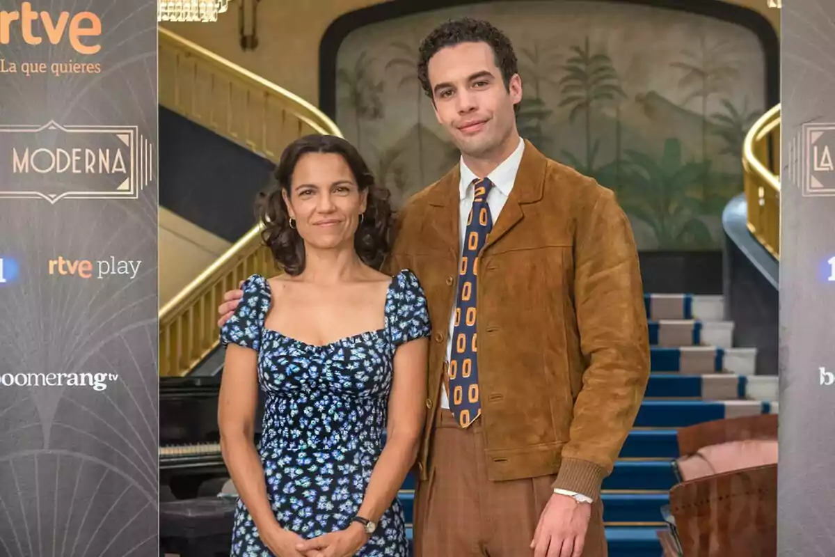 Diana Palazón y Jesús Mosquera juntas frente a una escalera, con un cartel de fondo que tiene los logotipos de RTVE, La Moderna y Boomerang TV. Diana Palazón y Jesús Mosquera juntas frente a una escalera, con un cartel de fondo que tiene los logotipos de RTVE, La Moderna y Boomerang TV.