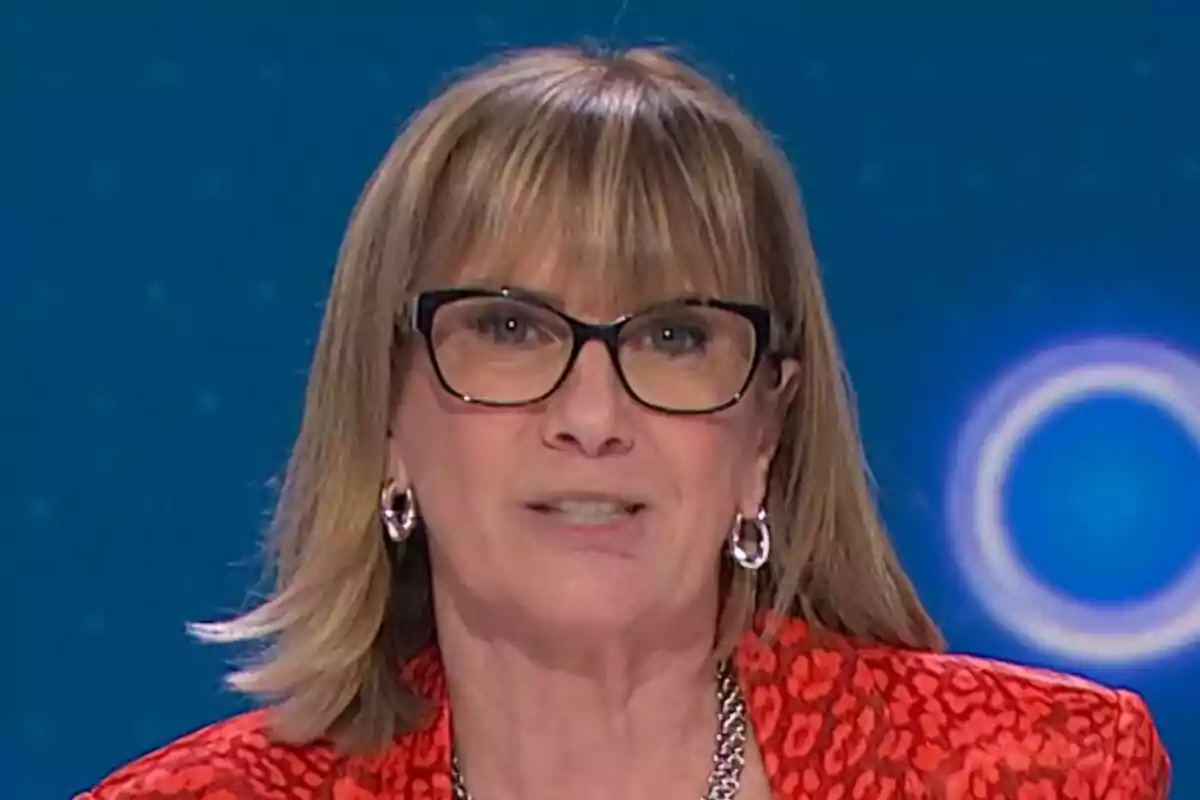 Gemma Nierga con gafas y cabello rubio, vistiendo una chaqueta roja con estampado, aparece en un entorno de estudio de televisión en 59 segundos.