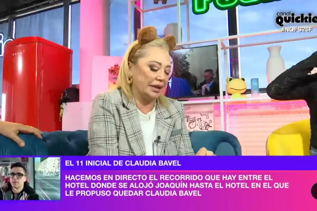 Belén Esteban con diadema de orejas de oso está sentada en un sofá azul en 'Ni que fuéramos', con un refrigerador rojo al fondo y un letrero verde en la pared; en la parte inferior de la imagen hay un recuadro con texto y una pequeña imagen de un hombre con gafas. Belén Esteban con diadema de orejas de oso está sentada en un sofá azul en 'Ni que fuéramos', con un refrigerador rojo al fondo y un letrero verde en la pared; en la parte inferior de la imagen hay un recuadro con texto y una pequeña imagen de un hombre con gafas.