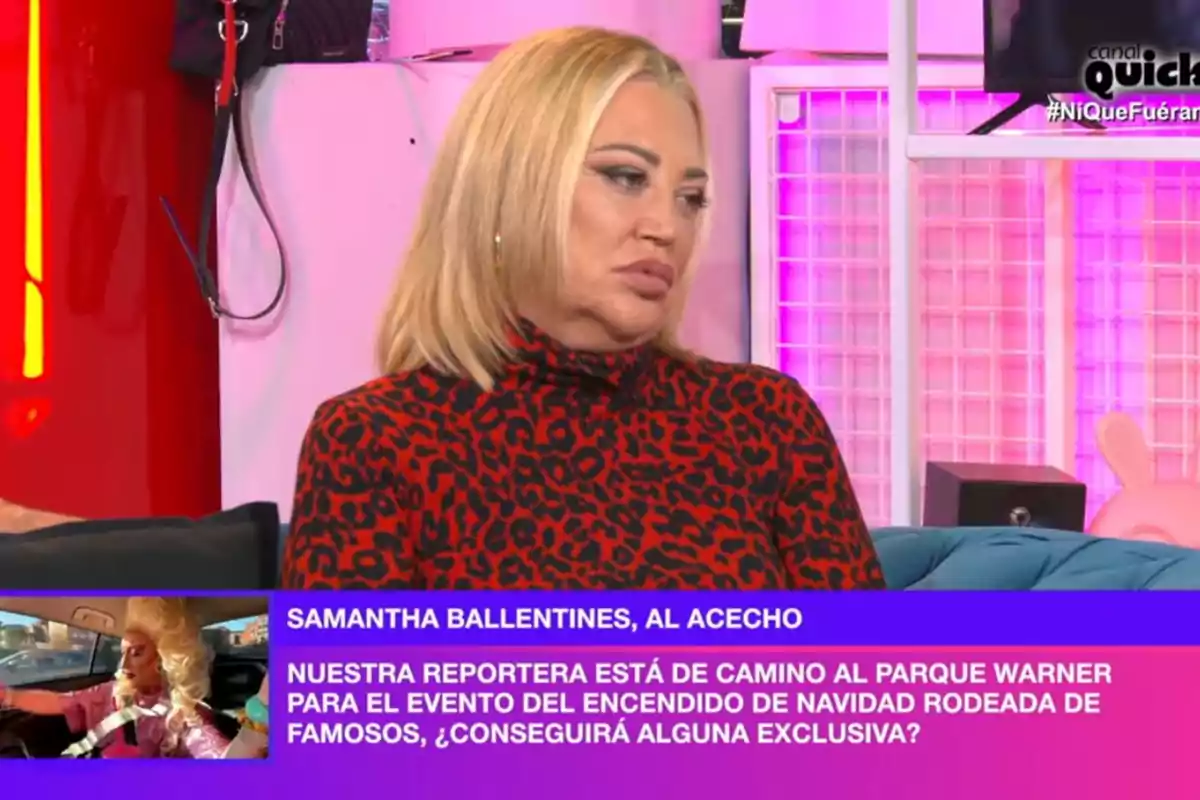 Belén Esteban con cabello rubio y suéter de estampado animal está sentada en 'Ni que fuéramos' con luces rosadas y decoración moderna. En la esquina inferior izquierda, hay un recuadro con texto que menciona a una reportera en camino a un evento navideño en el Parque Warner. Belén Esteban con cabello rubio y suéter de estampado animal está sentada en 'Ni que fuéramos' con luces rosadas y decoración moderna. En la esquina inferior izquierda, hay un recuadro con texto que menciona a una reportera en camino a un evento navideño en el Parque Warner.