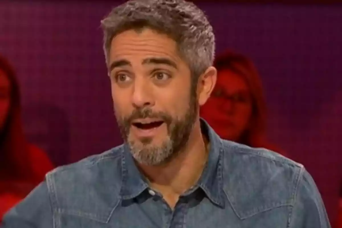 Pla curt de Roberto Leal amb barba i cabell canós parlant en un programa de televisió amb fons desenfocat.