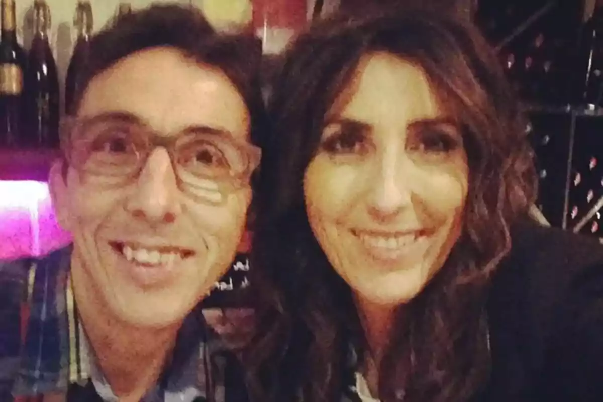 Paz Padilla junto a su hermano Luis Padilla sonríen mientras posan para una selfie en un ambiente interior con botellas al fondo. Paz Padilla junto a su hermano Luis Padilla sonríen mientras posan para una selfie en un ambiente interior con botellas al fondo.
