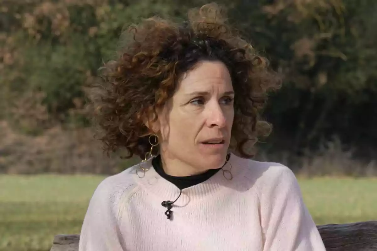 Marta Marco con cabello rizado y suéter claro sentada al aire libre en Off The Rec.