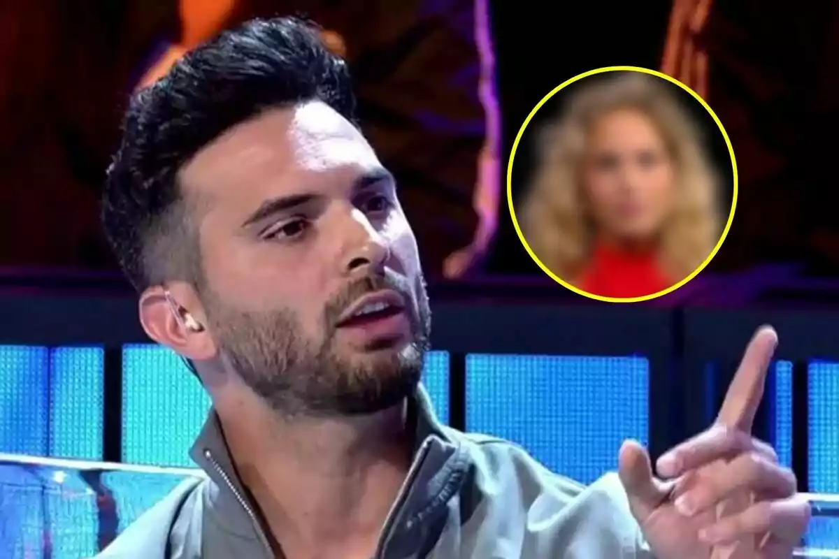 Suso Álvarez amb barba i cabell fosc està parlant i gesticulant en el debat de Gran hermano amb una imatge borrosa de la concursant Violeta en un cercle groc al fons.