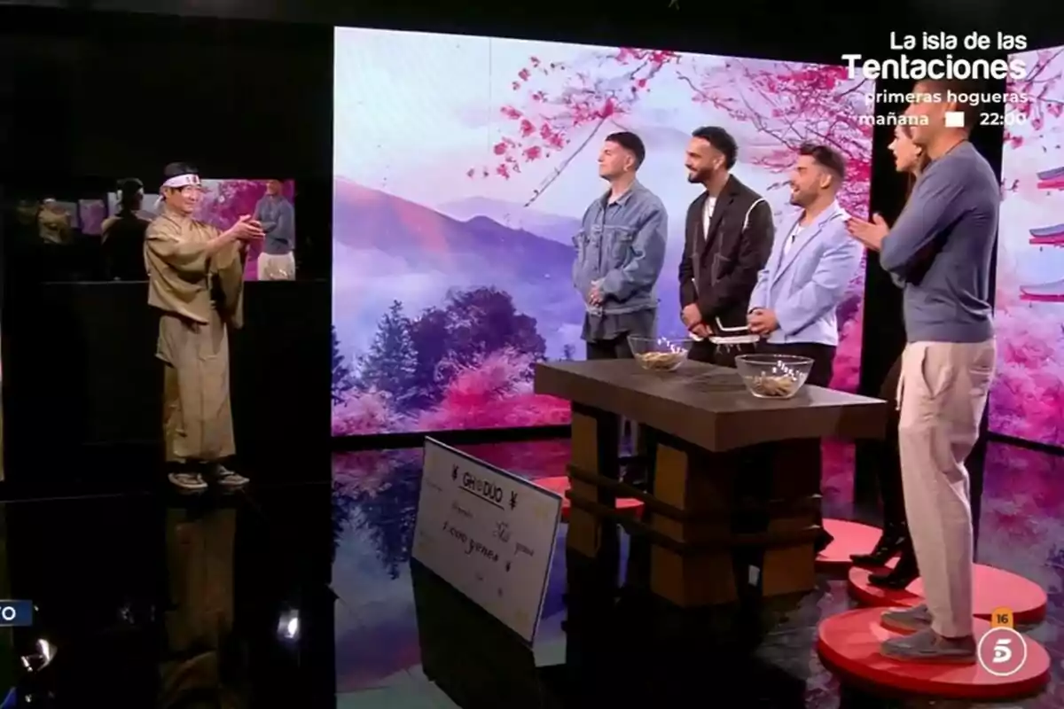 Sergio Aguilera, Manuel Cortés, Miguel Frigenti, Maica Benedicto i Álex Ghita és a GH DÚO amb una decoració de fons que inclou paisatges d'arbres i muntanyes, mentre un home vestit amb un quimono sosté un objecte davant seu.