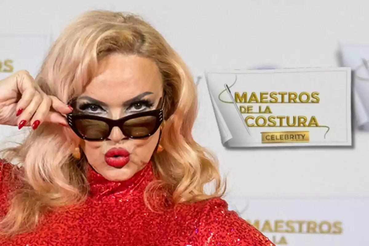 Silvia Superstar con cabello rubio y gafas de sol posa frente a un cartel que dice "Maestros de la Costura Celebrity".