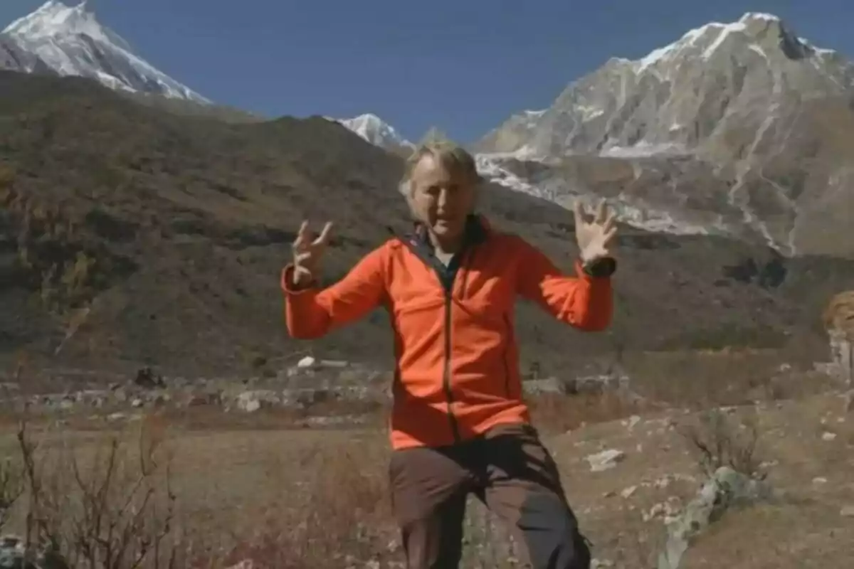 Jesús Calleja con chaqueta naranja está de pie en un paisaje montañoso con picos nevados al fondo en Universo Calleja. Jesús Calleja con chaqueta naranja está de pie en un paisaje montañoso con picos nevados al fondo en Universo Calleja.